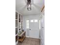 Bright entryway with white door, side-panel windows, decor table and decorative lighting at 1533 Findlay St, Deltona, FL 32725
