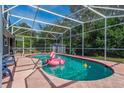 Sparkling screened pool surrounded by lush greenery and a clear blue sky at 1533 Findlay St, Deltona, FL 32725