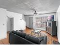 Cozy living room featuring a comfortable sofa, ceiling fan, and a large window for natural light at 3390 Cedar Spring Pl # 163, Winter Park, FL 32792