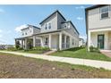 Stylish two-story home featuring modern design, covered porch, and easy sidewalk access at 5015 Railroad Vine Aly, Winter Garden, FL 34787