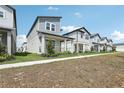 Street view of attractive two-story homes with modern design, covered porches, and manicured landscaping at 5015 Railroad Vine Aly, Winter Garden, FL 34787