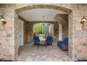 Charming covered patio area with stone columns and comfortable seating, perfect for relaxing outdoors at 8407 River Branch Pl, Sanford, FL 32771