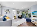 Bright living room featuring contemporary decor, hardwood floors, and sliding glass doors to patio at 1062 Reams St, Longwood, FL 32750