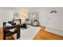 Bright living room featuring hardwood floors, stylish furniture, and large windows at 924 Beard Ave, Winter Park, FL 32789