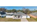 Aerial view showing a house with a gray roof and a fenced-in backyard at 1460 3Rd Ave, Deland, FL 32724