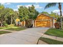 One-story house with attached garage and lush landscaping at 20575 Nettleton St, Orlando, FL 32833