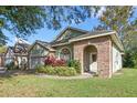 Inviting single-story home with brick accents, lush landscaping, and a well-manicured lawn at 2801 Ripton Ct, Orlando, FL 32835