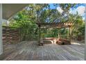 Spacious outdoor deck featuring a pergola with built-in seating, perfect for entertaining guests at 2801 Ripton Ct, Orlando, FL 32835