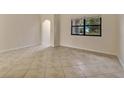 Spacious living area with tile floors and access to hallway at 3629 Peaceful Pl, Orlando, FL 32810