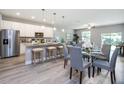 Open-concept kitchen featuring stainless steel appliances, granite countertops, and a breakfast bar for casual dining at 0 Paddock St, Orlando, FL 32833
