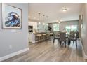 Inviting living space with modern flooring, leading to a kitchen with a breakfast bar and dining area at 0 Paddock St, Orlando, FL 32833