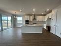 Bright, open kitchen with white cabinets, island, and stainless steel appliances at 5379 Park Guell St, St Cloud, FL 34771