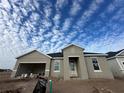 Newly constructed home with gray exterior, two-car garage, and covered entryway at 5385 Park Guell St, St Cloud, FL 34771