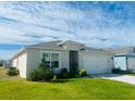 Inviting single-story home with a two-car garage and manicured front lawn at 2243 Tay Wes Dr, Saint Cloud, FL 34771