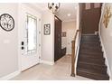 Bright and airy entryway with staircase, built-in storage and tile flooring at 1316 Fountain Hills Ct, Winter Park, FL 32792