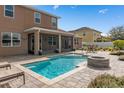 Relaxing backyard oasis featuring a refreshing pool and fire pit at 1316 Fountain Hills Ct, Winter Park, FL 32792