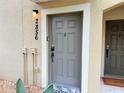 Close-up view of a gray front door with a welcome mat and the house numbers beside it at 2856 Oakwater Dr # 2856, Kissimmee, FL 34747
