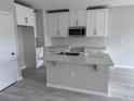 Modern kitchen featuring white cabinets, quartz countertops, and an island at 5084 Rain Shadow Dr, Saint Cloud, FL 34772