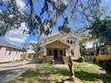 Charming two-story home with a classic front porch and mature trees, offering a blend of traditional design at 545 Margaret Ct, Orlando, FL 32801