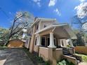 Classic home featuring a covered porch with decorative columns and an adjacent garage, showcasing the property's features at 545 Margaret Ct, Orlando, FL 32801