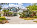 Charming two-story home with lush, tropical landscaping and a brick paved driveway at 7508 Lake Albert Dr, Windermere, FL 34786