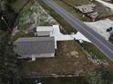 Aerial view of property featuring a driveway, home, metal garage, and surrounding land at 9650 Nw Gainesville Rd, Ocala, FL 34475