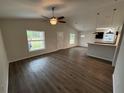 Bright living room boasts modern flooring, vaulted ceilings, and natural light from multiple windows at 9650 Nw Gainesville Rd, Ocala, FL 34475