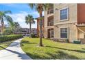 Ground level condo building with lush landscaping and a walkway at 5512 Metrowest Blvd # 110, Orlando, FL 32811