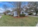 House with mature trees and manicured lawn in front at 6621 Bouganvillea Crescent Dr, Orlando, FL 32809