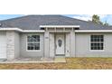 Close-up view of the home's entryway, featuring a white door and stone accents at 258 Fraser Rd, Debary, FL 32713