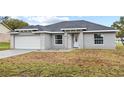 Newly built one-story house featuring gray siding, a white door, and stone accents at 258 Fraser Rd, Debary, FL 32713