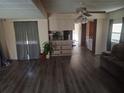 Spacious living room featuring vinyl flooring and a view into the kitchen at 34136 Carl Rd, Leesburg, FL 34788