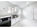 Modern kitchen with white cabinets, a stainless steel farmhouse sink, and contemporary fixtures at 1945 Piedmont Park Blvd, Apopka, FL 32703