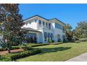Stunning two-story home with white siding, manicured lawn, and attached garage at 1948 Rowena Ave, Orlando, FL 32803