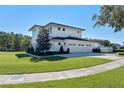 White two-story house with a three-car garage and a beautifully landscaped yard at 1948 Rowena Ave, Orlando, FL 32803
