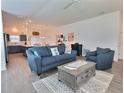 Open-concept living room featuring modern furnishings and seamless flow to the kitchen and dining area at 4694 Monica St, The Villages, FL 32163