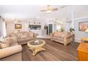 Spacious living room with hardwood floors, neutral paint, and large windows at 577 Sunridge Woods Blvd, Davenport, FL 33837