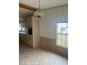 Dining area with light colored cabinets and tile floor at 3009 Manatee Rd, Tavares, FL 32778