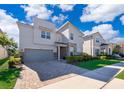 Contemporary home with gray exterior and paver driveway at 8956 Hilton Ridge Ave, Kissimmee, FL 34747