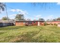 Large backyard of the house with spacious grass area at 2313 Savoy Dr, Orlando, FL 32808