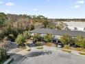 Aerial view of townhomes featuring private drives surrounded by green trees at 4457 Le Reve Ct, Kissimmee, FL 34746