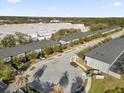 Wide aerial perspective of the townhome community showcasing its prime location near shopping and neighborhood amenities at 4457 Le Reve Ct, Kissimmee, FL 34746
