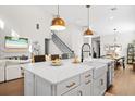 Spacious kitchen island featuring a white countertop, farmhouse sink, and stylish pendant lighting above at 777 Halifax Ave, Winter Park, FL 32792