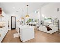 Bright, open-concept living space with kitchen island, modern lighting, and seamless flow to the living room at 777 Halifax Ave, Winter Park, FL 32792