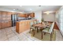 Charming kitchen featuring wooden cabinetry, stainless steel appliances and an adjacent dining area at 119 Lake Dr, Oviedo, FL 32765