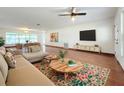 Spacious living room features hardwood floors, modern decor and lots of natural light at 119 Lake Dr, Oviedo, FL 32765