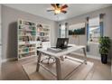 Home office with built-in shelves and a large desk at 15583 Hamlin Blossom Ave, Winter Garden, FL 34787