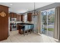 Bright kitchen with stainless steel appliances, dark wood cabinetry, and a breakfast bar with blue chairs at 2129 Victoria Glen Dr, Sanford, FL 32773