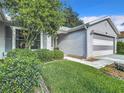 Exterior view of a gray house with landscaping at 3904 Plantation Blvd, Leesburg, FL 34748