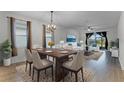 Bright dining room with hardwood floors and a wooden table, showcasing a spacious and well-lit area at 12037 Imaginary Way, Orlando, FL 32832